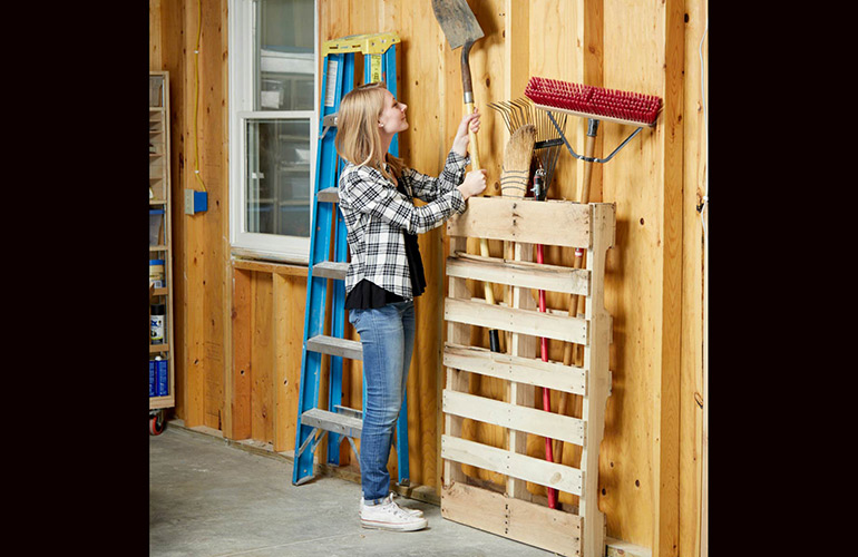 Use a pallet to store lawn and garden equipment