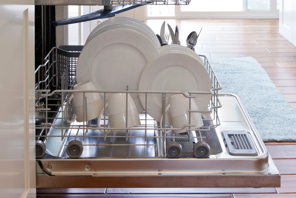Open dishwasher with white dishes stacked in shelves, How To Maintain Your Dishwasher , Handyman Magazine,