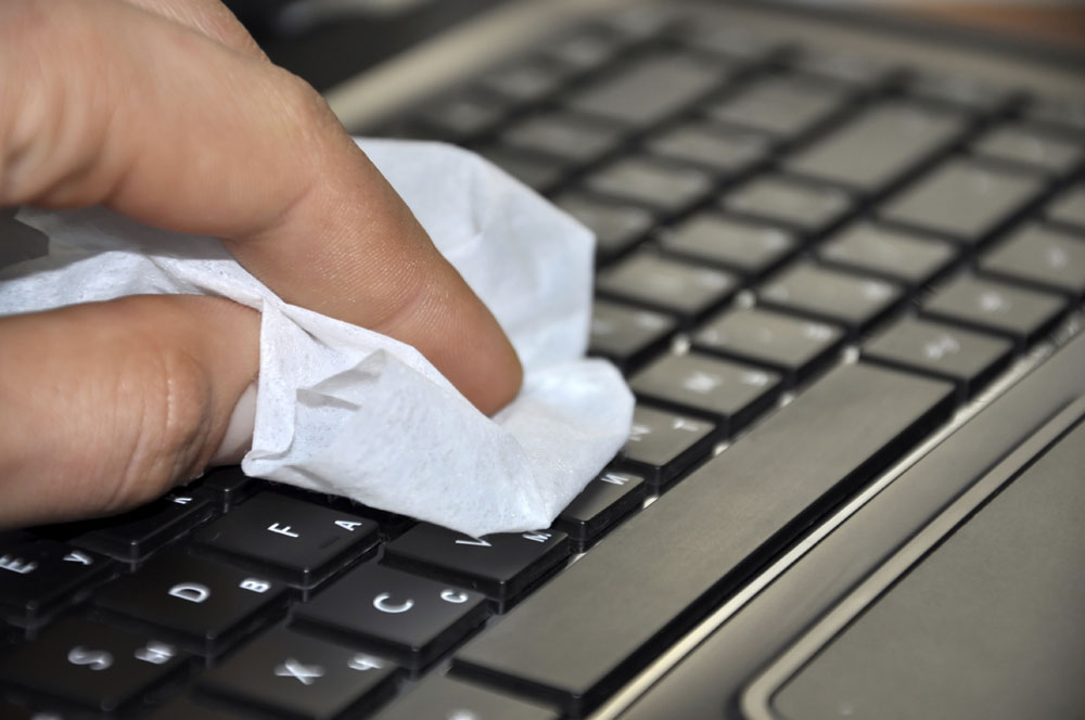 Wiping a keyboard with a lint-free cloth