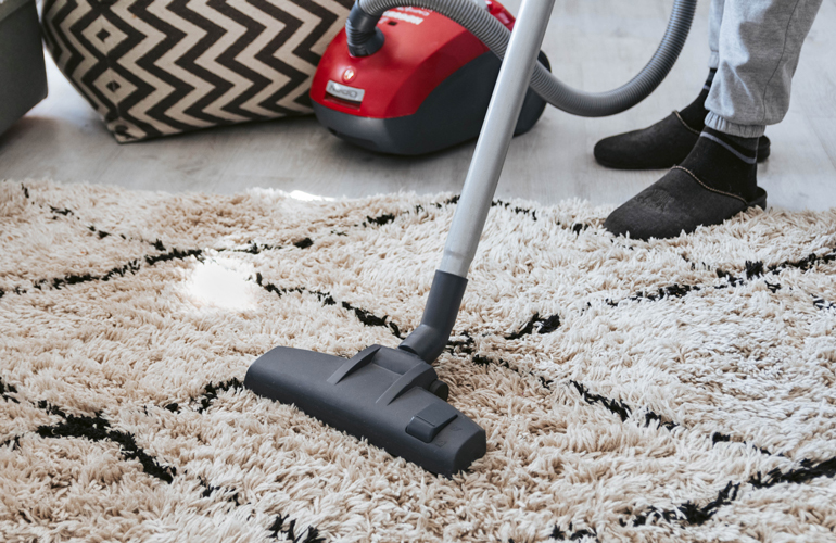 Vacuum the outdoor rug