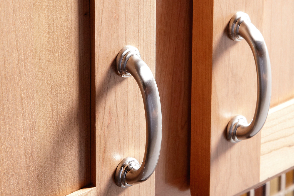 metal handle aligned to timber cabinet, tips for replacing cabinet handles and drawer knobs, handyman magazine,