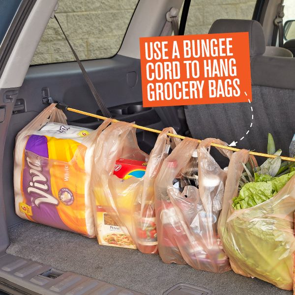 grocery bags hanging off a bungee cord in the backboot of a car, 
