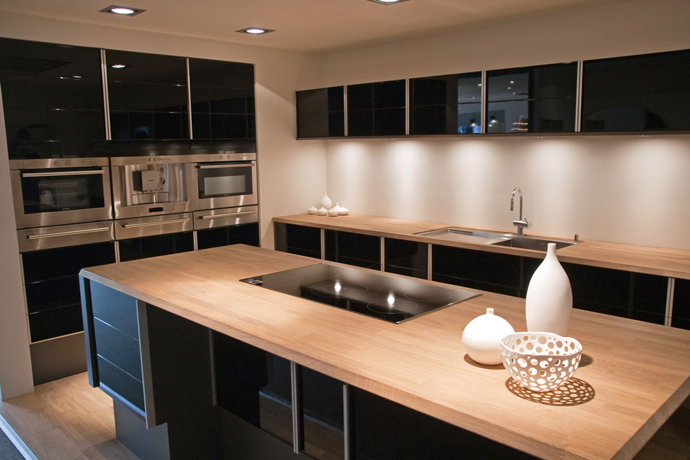 modern kitchen with laminate bench tops and black cabinetry 