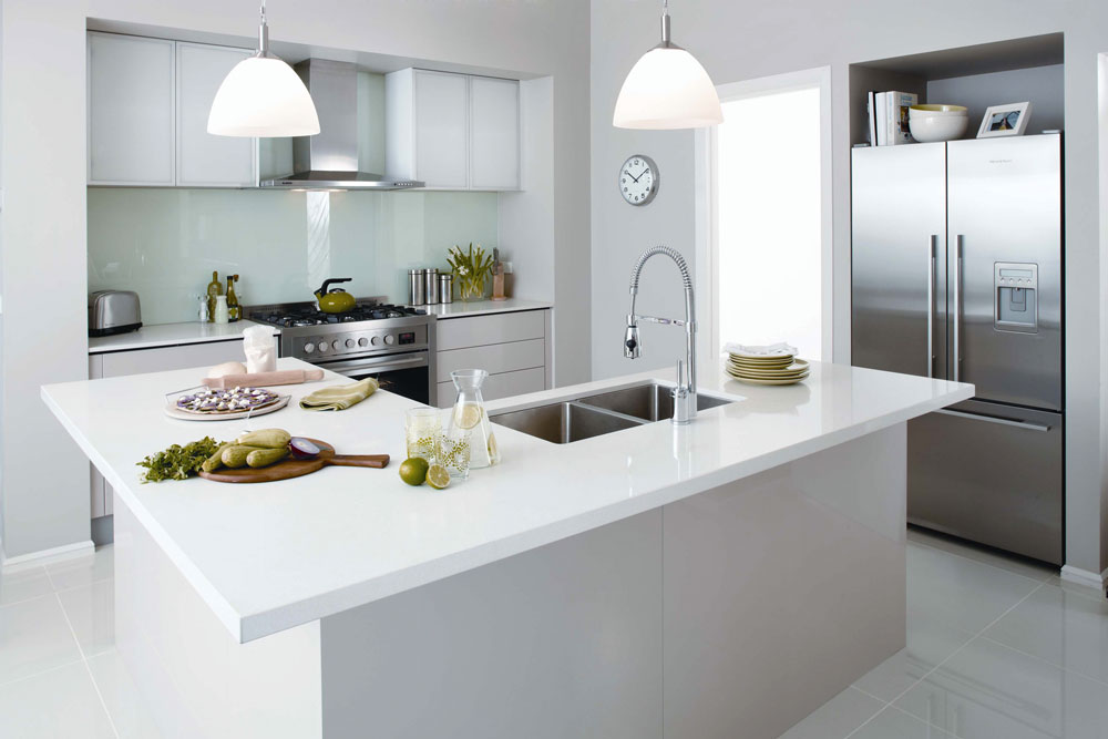 modern kitchen with white cabinetry and white pendant lights 