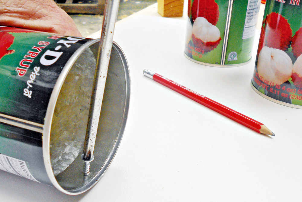 use a screw driver to add a nail to a can, 