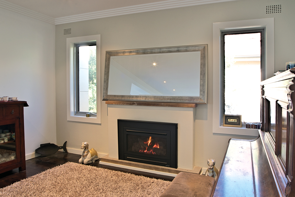 A living area with a fireplace after a renovation, Handyman Magazine 