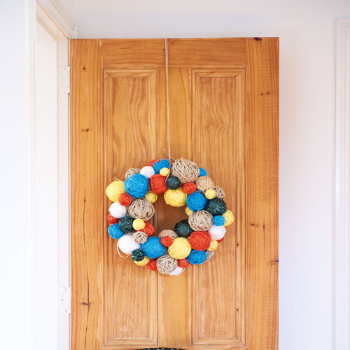 twine wreath hanging on a door 